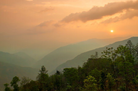 Beautiful sunrise in mountains of Himalayas, Hee Barmiok village of Sikkim, India. Great Himalayan mountain peaks in the background.の写真素材