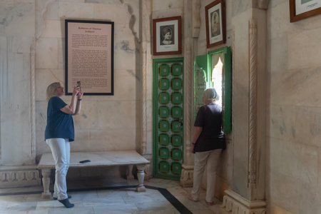 Jodhpur, Rajasthan, India - 20th October 2019 : Foreigner woman taking picture of her friend inside beautifully decorated hall of Jaswant Thada cenotaph, built with Makrana marble.のeditorial素材