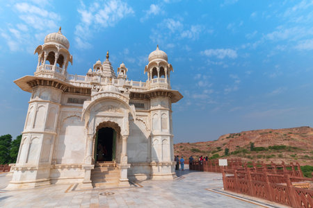 Jodhpur, Rajasthan, India - 20.10.2019 : Visitors enoying beautiful architecture of Jaswant Thada cenotaph. Makrana marble emitting warm glow when illuminated by the Sun. Blue sky background.のeditorial素材