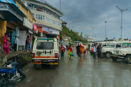 Pauri, Garhwal, Uttrakhand, India - 3rd November 2018 : Monsoon on the streets of Pauri. Rainy street image of busy town on the mountains of Himalayas. Climate change effect on Himalayas.のeditorial素材