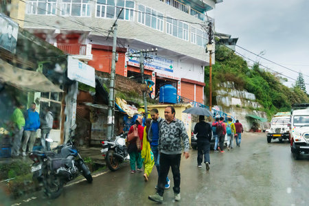 Pauri, Garhwal, Uttrakhand, India - 3rd November 2018 : Monsoon on the streets of Pauri. Rainy street image of busy town on the mountains of Himalayas. Climate change effect on Himalayas.のeditorial素材