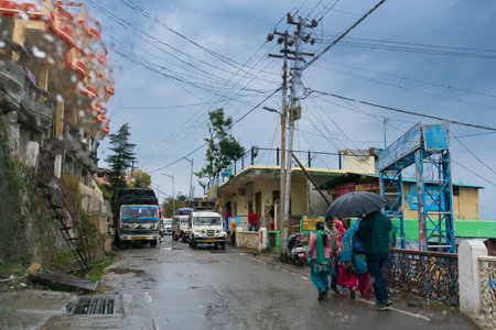 Pauri, Garhwal, Uttrakhand, India - 3rd November 2018 : Monsoon on the streets of Pauri. Rainy street image of busy town on the mountains of Himalayas. Climate change effect on Himalayas.のeditorial素材