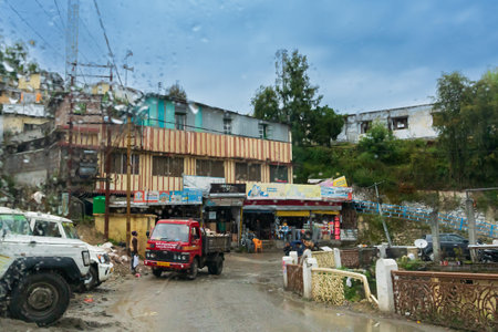 Pauri, Garhwal, Uttrakhand, India - 3rd November 2018 : Monsoon on the streets of Pauri. Rainy street image of busy town on the mountains of Himalayas. Climate change effect on Himalayas.のeditorial素材
