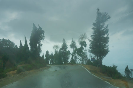 Monsoon on the hills, Himalayan mountains, Garhwal, Uttarakhand, India. Rainy image of the mountains of Himalayas. Climate change effect on Himalayas. Fog, haze of rain, muted color, shot thru' glass.の写真素材