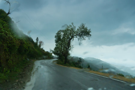 Monsoon on the hills, Himalayan mountains, Garhwal, Uttarakhand, India. Rainy image of the mountains of Himalayas. Climate change effect on Himalayas. Shot through glass.の写真素材