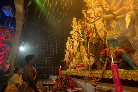 Howrah, West Bengal, India - 3rd October, 2022 : Hindu Priests praying and worshipping Goddess Durga inside Durga Puja pandal. Ashtami puja at night.Durga puja is unesco intangible cultural heritage.のeditorial素材