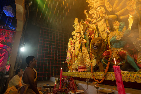 Howrah, West Bengal, India - 3rd October, 2022 : Hindu Priests praying and worshipping Goddess Durga inside Durga Puja pandal. Ashtami puja at night.Durga puja is unesco intangible cultural heritage.のeditorial素材