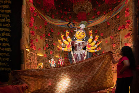Howrah, West Bengal, India - 3rd October, 2022 : Hindu Purohit worshipping Goddess Durga with Vog, offering holy food for the Goddess behind cover. Durga Puja ritual. Biggest festival of Hinduism.のeditorial素材