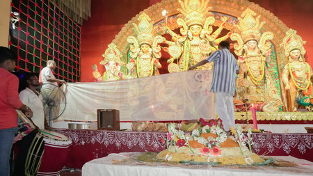 Howrah, West Bengal, India - 5th October, 2022 : Hindu Purohit worshipping Goddess Durga with Vog, offering holy food for the Goddess behind cover. Durga Puja ritual. Biggest festival of Hinduism.のeditorial素材