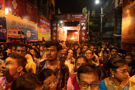 Kolkata, West Bengal, India- 4h October, 2022 : Hindu devotees gathered on decorated and illuminated street during Durga puja festival night to visit pandal.Durga puja is biggest festival of Hindusim.のeditorial素材