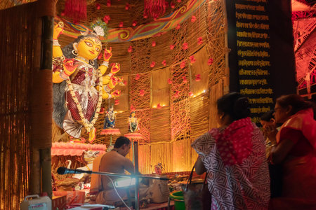 Howrah, West Bengal, India - 3rd October, 2022 : Hindu Purohit worshipping Goddess Durga with puja ingredients inside Durga Puja pandal. Durga Puja ritual. Biggest festival of Hinduism.のeditorial素材