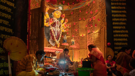 Howrah, West Bengal, India - 3rd October, 2022 : Hindu Purohit worshipping Goddess Durga with puja ingredients inside Durga Puja pandal. Durga Puja ritual. Biggest festival of Hinduism.のeditorial素材
