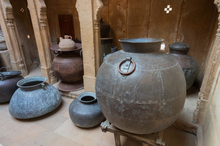 Jaisalmer, Rajasthan, India - 16 th October 2019 : Old kitchen with enormous metallic pots for cooking for big wealthy families of Ancient India. Preserved inside in-house museum of Patwon ki haveli.のeditorial素材