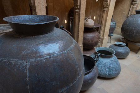 Jaisalmer, Rajasthan, India - 16 th October 2019 : Old kitchen with enormous metallic pots for cooking for big wealthy families of Ancient India. Preserved inside in-house museum of Patwon ki haveli.のeditorial素材