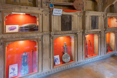 Jaisalmer, Rajasthan, India - 16th October 2019 : Tambura, Dholak, Sindhi Sarangi, Kamaicha and other musical instruments of ancient Rajasthan, preserved in in-house museum of Patwon ki haveli.のeditorial素材