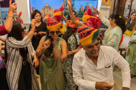 Jodhpur, Rajasthan, India - 19.10.2019 : Ladies wearing traditional colorful wedding turbans, dancing in Joy, happiness for celebration of Sindhi marriage organized in a hotel. Destination wedding.のeditorial素材