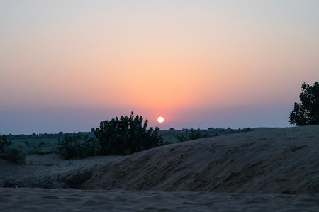 Sun rising at the horizon of Thar desert, Rajasthan, India. Tourists from across India visits to watch desert sun rise at Thar desert.の写真素材