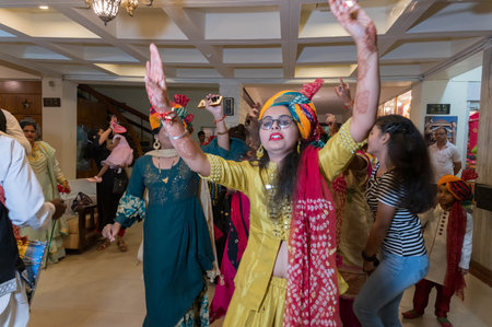 Jodhpur, Rajasthan, India - 19.10.2019 : Females wearing traditional colorful wedding turbans, dancing in Joy, happiness for celebration of Sindhi marriage organized in a hotel. Destination wedding.のeditorial素材