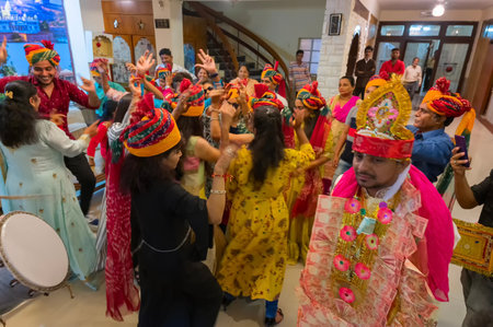 Jodhpur, Rajasthan, India - 19.10.2019 : Ladies wearing traditional colorful wedding turbans, dancing in Joy, happiness for celebration of Sindhi marriage organized in a hotel. Destination wedding.のeditorial素材