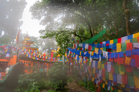 Darjeeling,West Bengal,India-11.08.2023: Flags on stair cases in forest,way to Mahakal Temple or Mahakal Mandir, Hindu temple dedicated to God Shiva, an amalgamation of Hindu and Buddhist religions.のeditorial素材