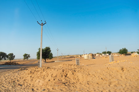 Ranautar, remote desert village inside the desert. Distant horizon, Hot summer with cloudless clear blue sky background, Thar desert, Rajasthan, India.の写真素材