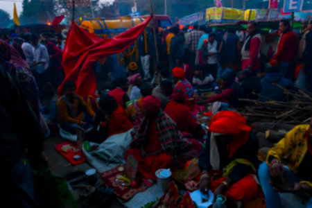 Blurred image of Devotees walking at Gangasagar transit camp to visit Hindu sadhus at their camps ,...