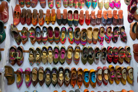 Pairs of colorful Rajasthani womens' shoes at display for sale. Jaisalmer, Rajasthan, India.の写真素材