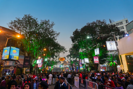 Kolkata, West Bengal, India - 26.12.2018 : Christmas celebration by enthusiastic young public at illuminated and decorated park street with lights and year end festive mood. Blue sky background.のeditorial素材