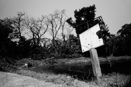 White blank sign board beside a lake, nature in black and white.の写真素材