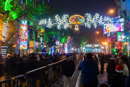 Kolkata, West Bengal, India - 26.12.2018 : Christmas celebration by enthusiastic young public at illuminated and decorated park street with lights and year end festive mood. Evening sky background.の写真素材