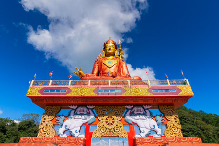 Holy statue of Guru Padmasambhava or born from a lotus, Guru Rinpoche, was a Indian tantric Buddhist Vajra master who taught Vajrayana in Tibet. Blue sky and white clouds, Samdruptse, Sikkim, India.の写真素材