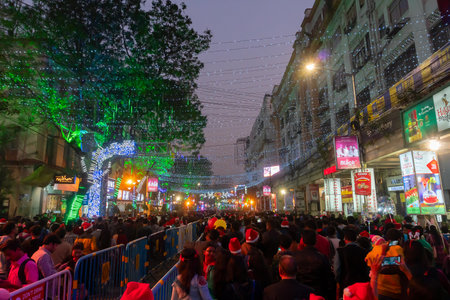 Kolkata, West Bengal, India - 26.12.2018 : Christmas celebration by enthusiastic young public at illuminated and decorated park street with lights and year end festive mood. Evening sky background.のeditorial素材
