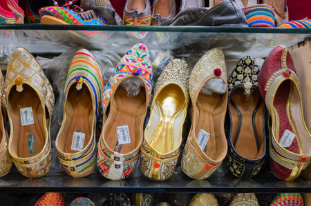 Jodhpur, Rajasthan, India - 18th October 2019 : Pairs of Rajasthani ladies' shoes at display for sale. Rajasthani shoes are famous for their style and varieties and are sold all over India.のeditorial素材