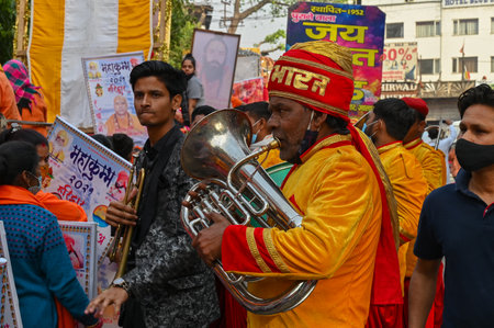 Haridwar, Uttarakhand, India - 13th April 2021 : Hindu devotee playing bugle, signalling brass...