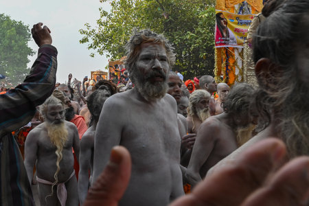 Haridwar, Uttarakhand, India - 13th April 2021 : Purno Kumbhmela event. Hindu naked sadhus, naga babas, naga sanyasis running for having shahi snaan on river Ganges and shouting Har Har Mahadev.のeditorial素材