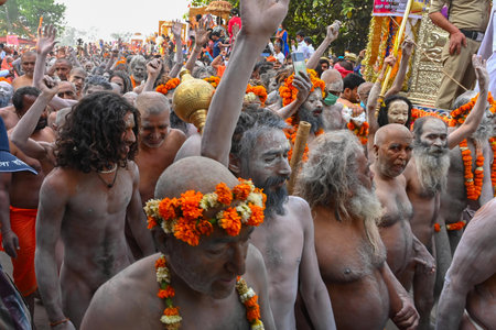 Haridwar, Uttarakhand, India - 13th April 2021 : Purno Kumbhmela event. Hindu naked sadhus, naga babas, naga sanyasis running for having shahi snaan on river Ganges and shouting Har Har Mahadev.のeditorial素材