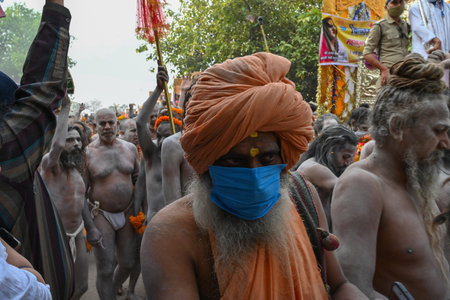 Haridwar, Uttarakhand, India - 13th April 2021 : Purno Kumbhmela event. Hindu naked sadhus, naga babas, naga sanyasis running for having shahi snaan on river Ganges and shouting Har Har Mahadev.のeditorial素材