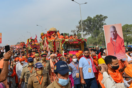 Haridwar, Uttarakhand, India - 13th April 2021 : Hindu sadhus, sanyasis in saffron dresses on tractors in procession for shahi snaan on Holy river Ganges. Maha Kumbhmela event, Hinduism in India.のeditorial素材