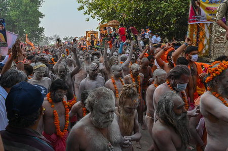 Haridwar, Uttarakhand, India - 13th April 2021 : Purno Kumbhmela event. Hindu naked sadhus, naga babas, naga sanyasis running for having shahi snaan on river Ganges and shouting Har Har Mahadev.のeditorial素材