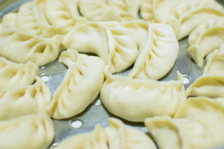 Close up of Momo, type of South Asian dumpling; native to Tibet, Nepal, Bhutan and Sikkim. It is similar to Chinese baozi and jiaozi, Mongolian buuz, Japanese gyoza and Korean mandu. Stock photograph.の写真素材