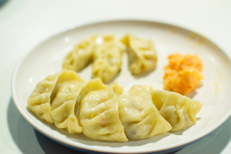 Momo , type of South Asian dumpling; native to Tibet, Nepal, Bhutan and Sikkim. It is similar to Chinese baozi and jiaozi, Mongolian buuz, Japanese gyoza and Korean mandu. Stock photograph.の写真素材