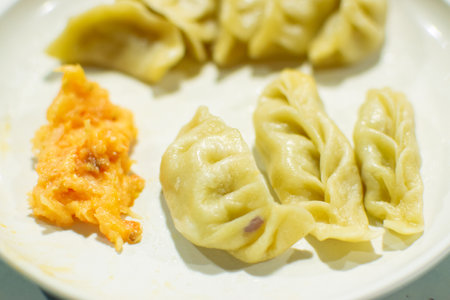Momo , type of South Asian dumpling; native to Tibet, Nepal, Bhutan and Sikkim. It is similar to Chinese baozi and jiaozi, Mongolian buuz, Japanese gyoza and Korean mandu. Stock photograph.の写真素材