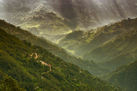 Sun rays falling on Himalayan mountain range, scenic beauty of layers of mountains, Okhrey, sikkim,...