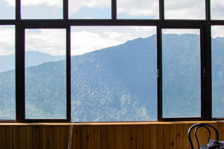 Window with beautiful view of Himalayan mountains outside. Homestay at Sikkim, West Bengal, India.