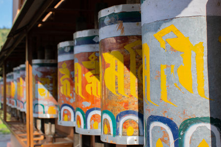 Prayer wheels, or mani wheels, cylindrical wheels for Buddhist recitation. Traditionally, a mantra like Om mani padme hum , is written on the outside of the wheel. Okhrey Monastery, Sikkim, India.の写真素材