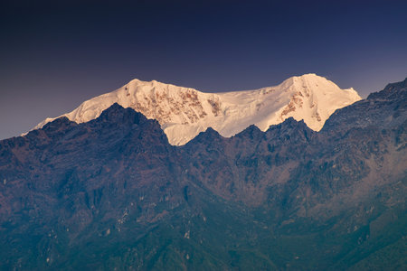 Beautiful first light from sunrise on Mount Kabru, part of ridge that extends south from third highest mountain in the world Kangchenjunga, Himalayan mountain range, Sikkim, India. Nepal India border.の写真素材