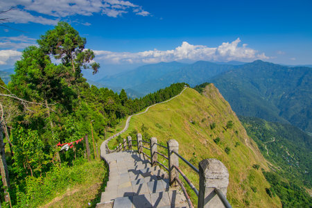 Stair case from foreground towards Himalayan mountains in horizon, Tarey Bhir point, famous tourist spot, Sikkim, India. The word 'Bhir' means cliff in the local Nepal language,long path for tourists.の写真素材