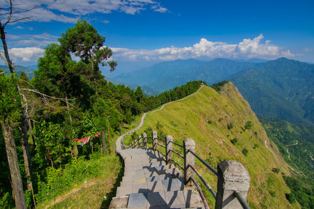 Stair case towards Himalayan mountains in horizon and blue sky, Tarey Bhir point, famous tourist spot, Sikkim, India. The word 'Bhir' means cliff in the local Nepal language,long path for tourists.の写真素材