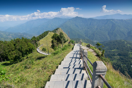 Stair case towards Himalayan mountains in horizon and blue sky, Tarey Bhir point, famous tourist spot, Sikkim, India. The word 'Bhir' means cliff in the local Nepal language,long path for tourists.の写真素材