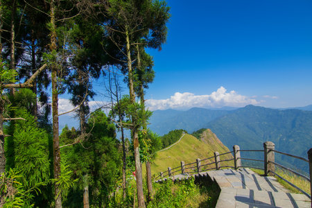 Stair case towards Himalayan mountains in horizon and blue sky, Tarey Bhir point, famous tourist spot, Sikkim, India. The word 'Bhir' means cliff in the local Nepal language,long path for tourists.の写真素材